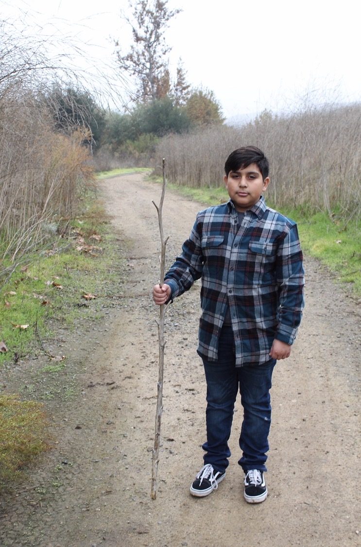 Youth portrait — boy on trail